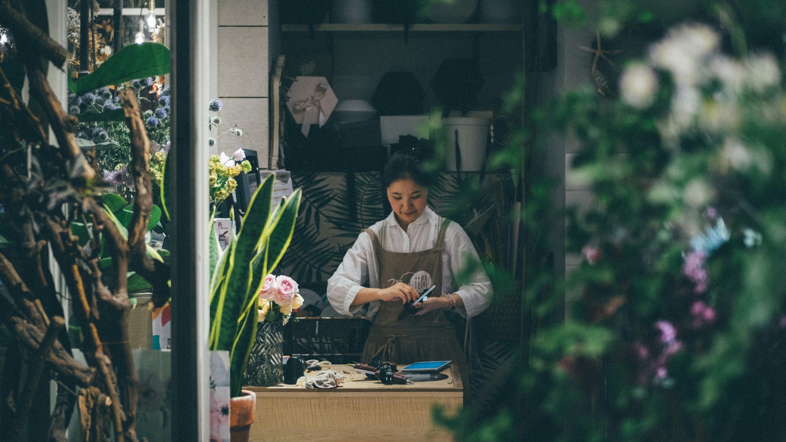 A small business owner working at her shop counter